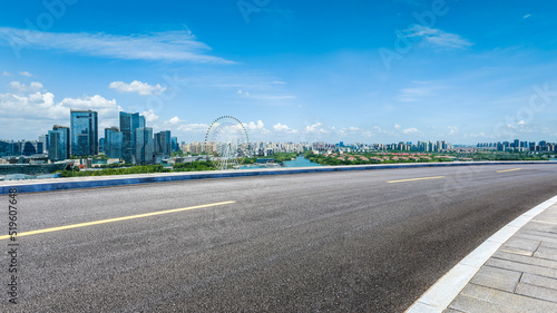Empty asphalt road and city skyline with modern buildings scenery