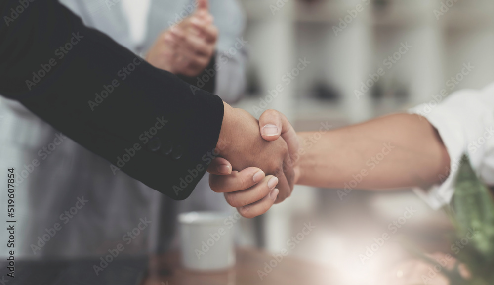 Image of Successful businessmen partnership handshaking after acquisition. Meeting for sign contracts and Group support concept.