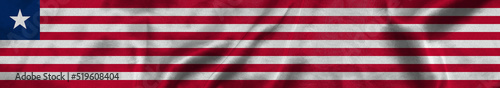 Elongated national flag of Liberia with a fabric texture fluttering in the wind. Liberian flag for website design. 3d illustration