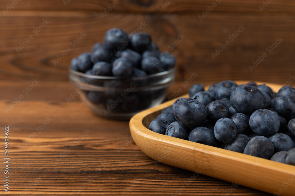 Blueberries in a bowl on a brown textured background. Ripe and fresh blueberries. Vitamins. Healthy food. Juicy berry. Copy space. Place for text Blueberries in a bowl on a brown textured background. Ripe and fresh blueberries. Vitamins. Healthy food. Juicy berry. Copy space. Place for text