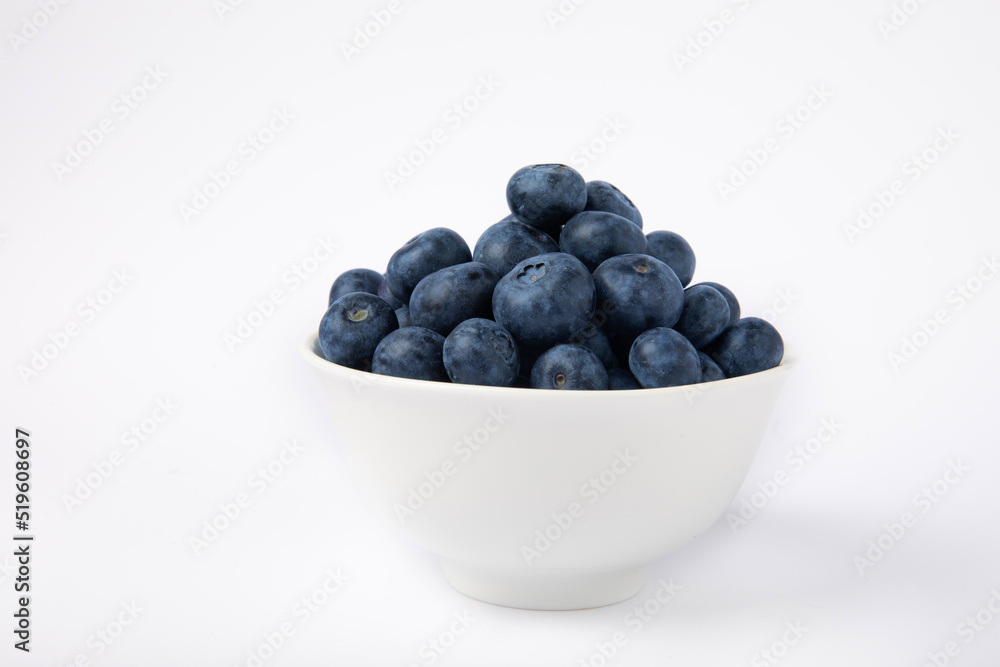 Blueberries in a bowl isolated on a white background. Ripe and fresh blueberries. Vitamins. Healthy food. Juicy berry. Copy space. Place for text Blueberries in a bowl isolated on a white background. Ripe and fresh blueberries. Vitamins. Healthy food. Juicy berry. Copy space. Place for text