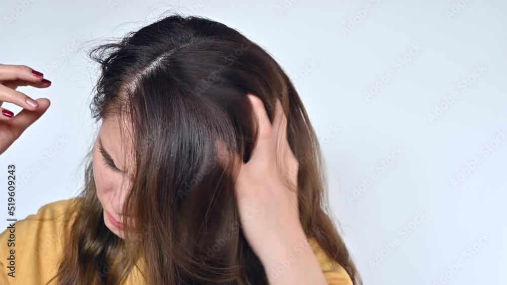 Asian woman scratching her scalp caused of itchy scalp.