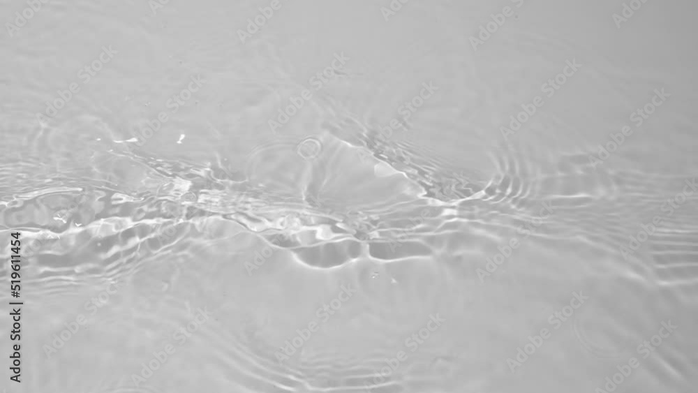Transparent clear calm water surface texture with waves, splashes and bubbles. Trendy abstract nature background. White grey water waves in sunlight. Slow motion Full HD video banner. Transparent clear calm water surface texture with waves, splashes and bubbles. Trendy abstract nature background. White grey water waves in sunlight. Slow motion Full HD video banner.