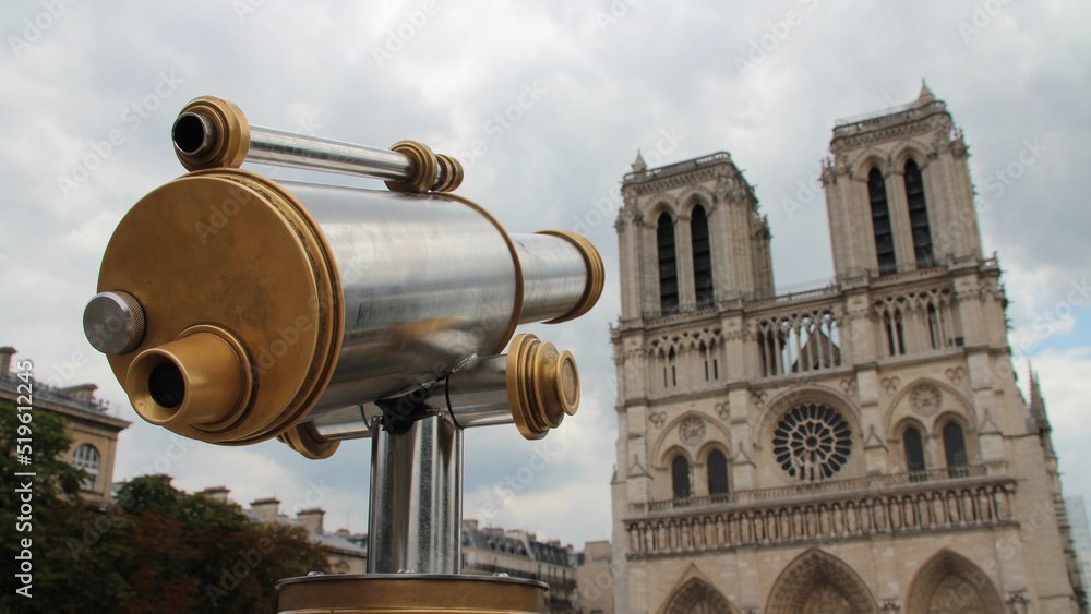 spotting scope and notre-dame cathedral in paris (france)