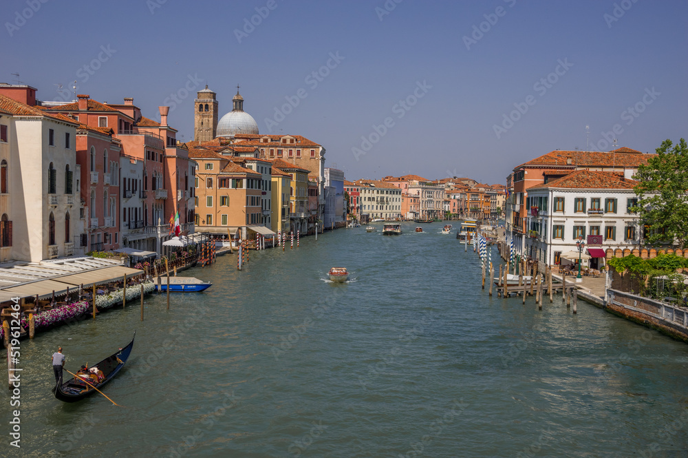 Grand channel in Venice, holiday season, gondola and boats in the background of the traditional Venetian architecture