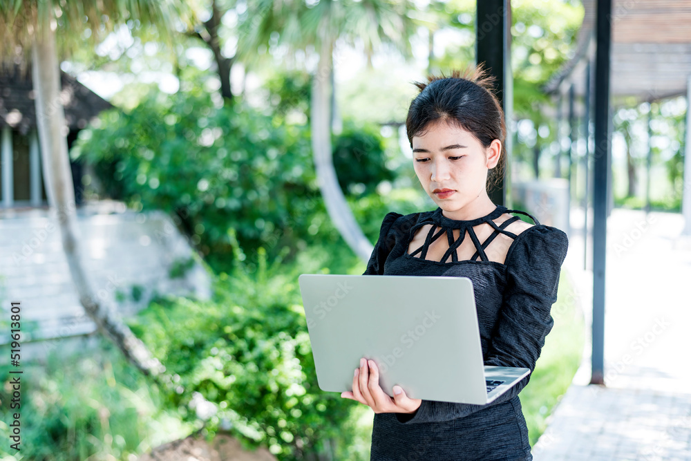 Beautiful businesswoman in black working on laptop . Comfortable work or remote work concept. Beautiful businesswoman in black working on laptop . Comfortable work or remote work concept.