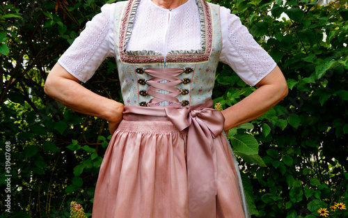 a woman in a beautiful traditional Bavarian dirndl or also Austrian dirndl (also called Tracht) at the Bavarian October fest (Oktoberfest) (Munich, Bavaria, Germany)	