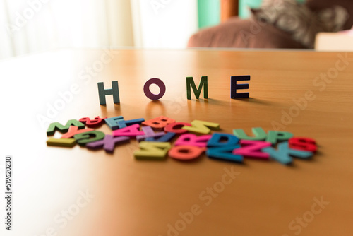 The word Home in colored letters on a wooden background