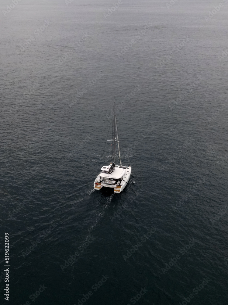 Moody drone shot of a boat crusing in the sea