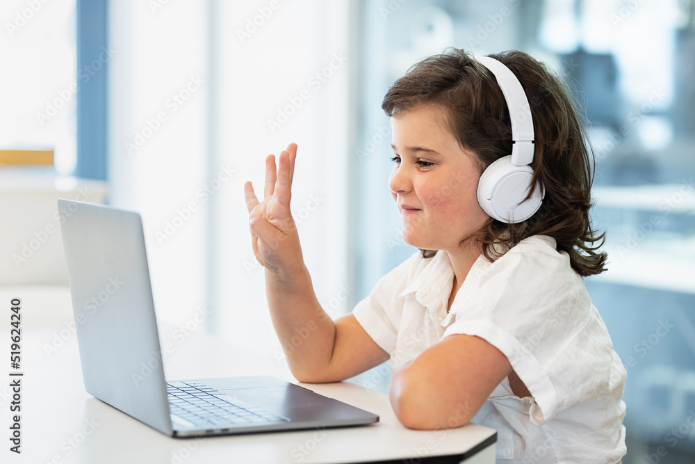 Girl sitting in front of a laptop at home Girl sitting in front of a laptop at home