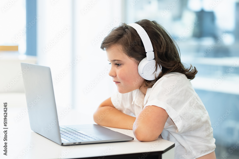 Girl sitting in front of a laptop Girl sitting in front of a laptop