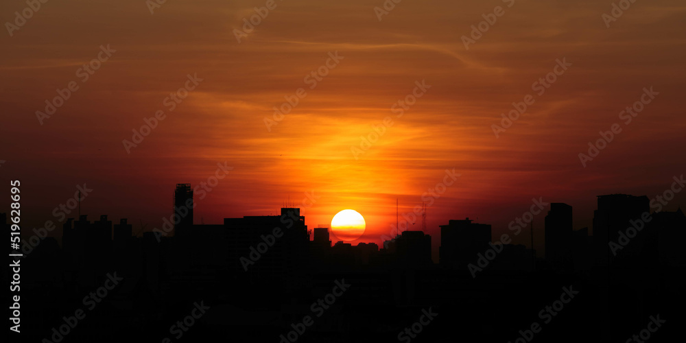 Silhouette shot of sunrise over city of bangkok, thailand