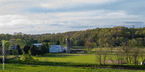 Amish farm with a silo in the lush green countryside of Holmes County, Ohio