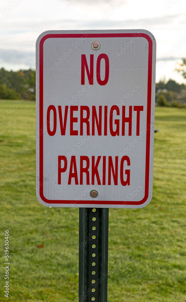 No Overnight Camping sign with a mowed lawn in the background.