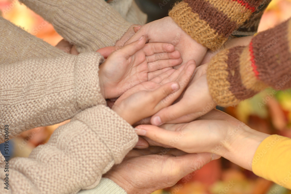 cropped image, family putting hands together cropped image, family putting hands together
