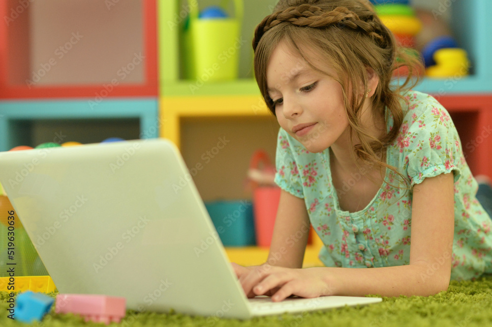cute little girl using laptop at home cute little girl using laptop at home