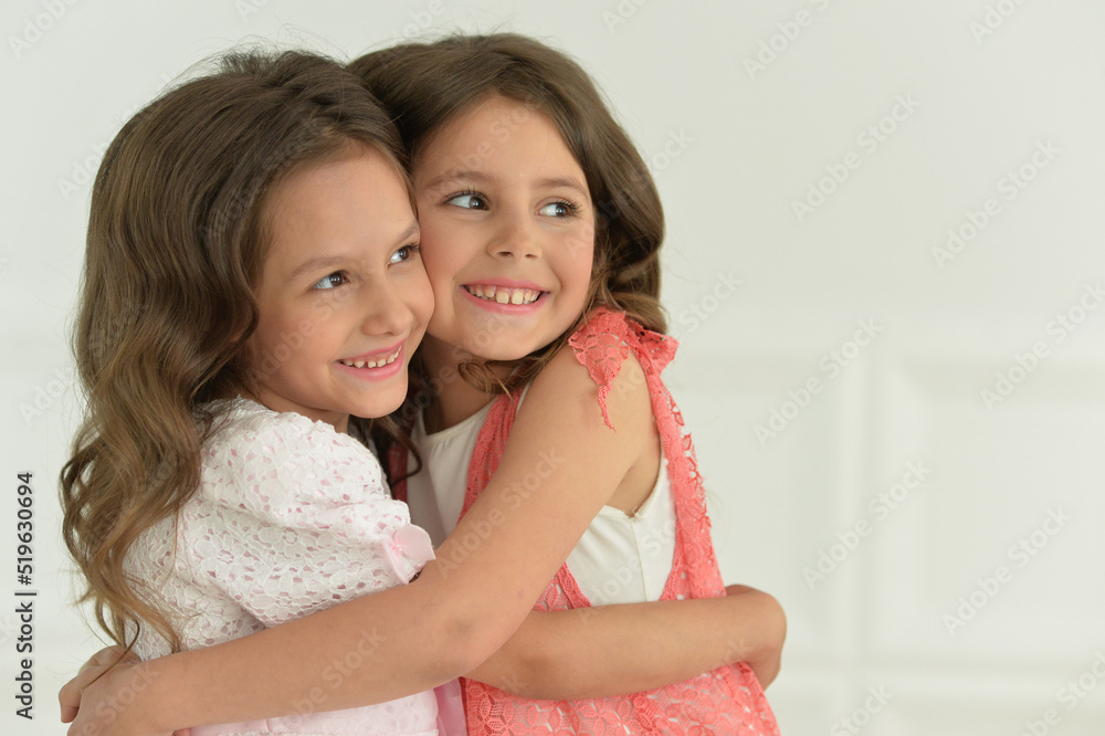 Studio portrait of cute twin sisters posing Studio portrait of cute twin sisters posing