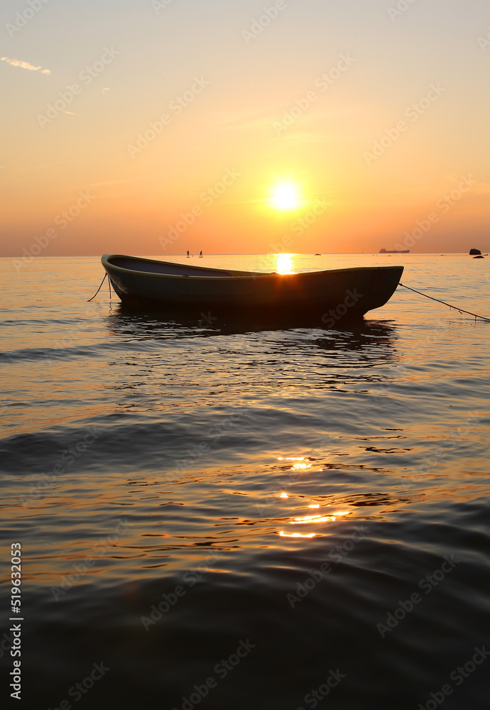 lonely boat in the sea at sunset lonely boat in the sea at sunset