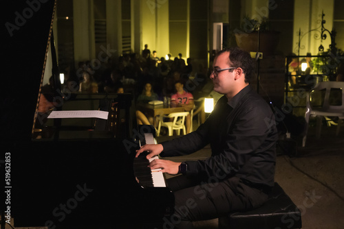 close-up of a pianist playing at an open-air concert