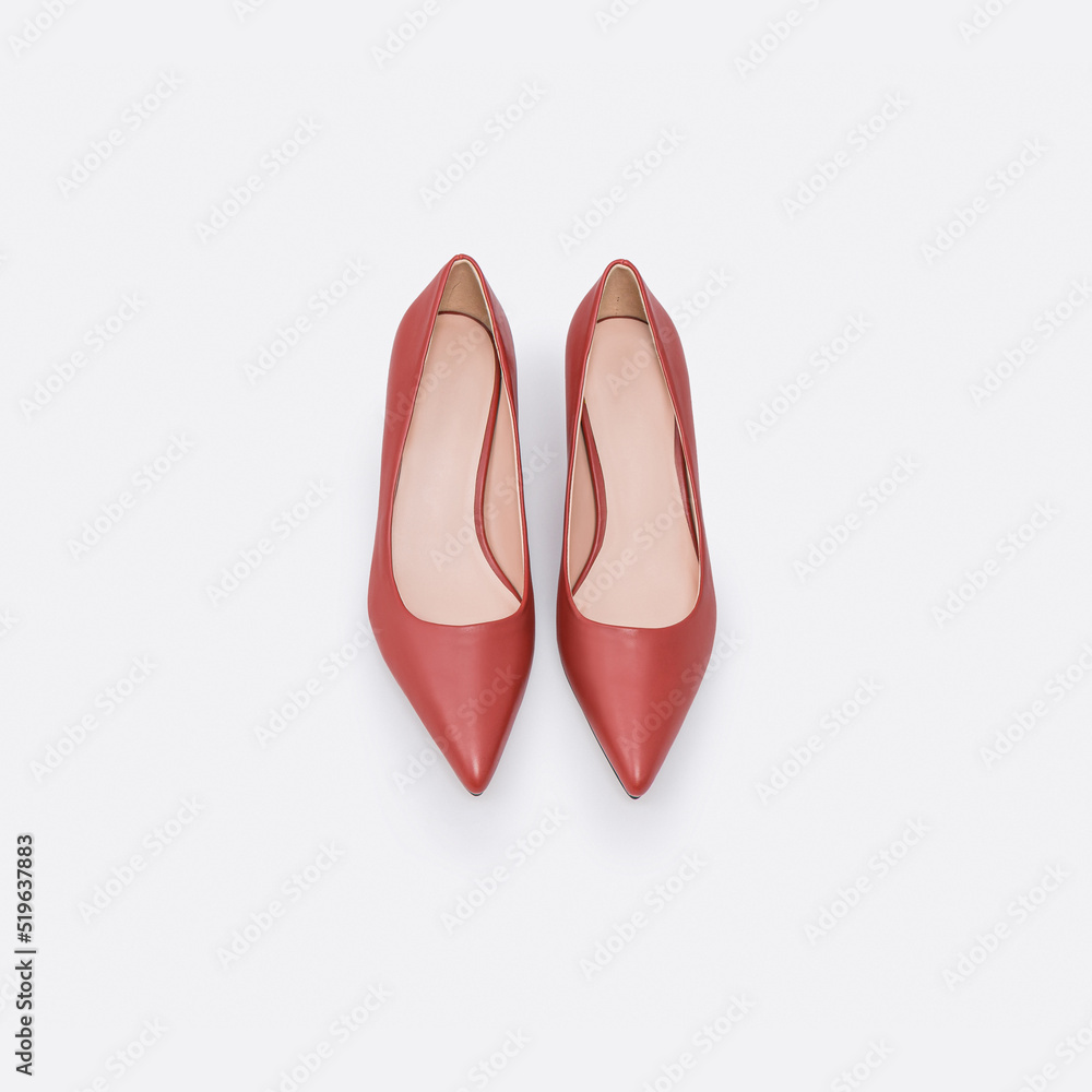 Beautiful beige lether fashion female shoes isolated on white background; top view Beautiful beige lether fashion female shoes isolated on white background; top view