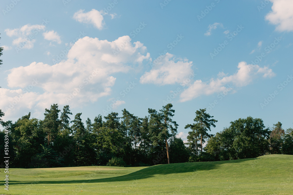 Beautiful sunny summer landscape with a green golf course 