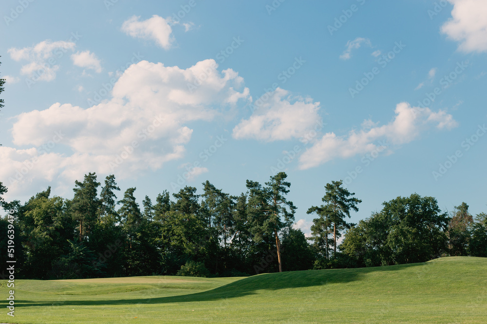 Beautiful sunny summer landscape with a green golf course Beautiful sunny summer landscape with a green golf course