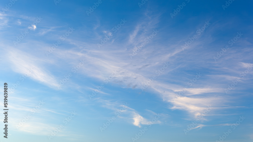 White fluffy clouds on blue clear sky