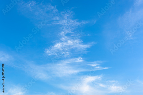 Sky blue background, light clouds in the blue sky