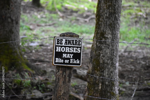 Warning sign beware horses might bite or kick