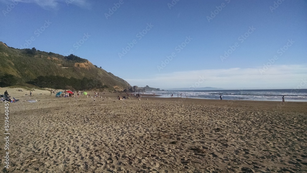Beach close to mountains on a summer day with a blue sky Beach close to mountains on a summer day with a blue sky