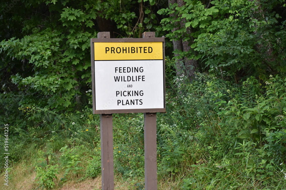 warning sign for prohibited feeding wildlife and picking plants