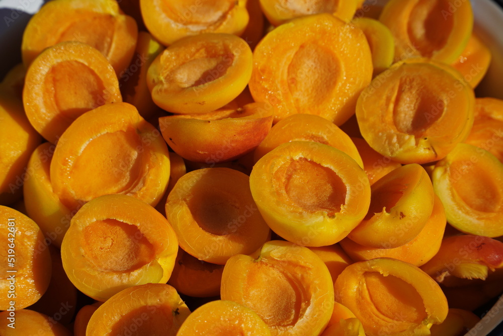 Slices of Ripe yellow apricots close-up, top view Slices of Ripe yellow apricots close-up, top view