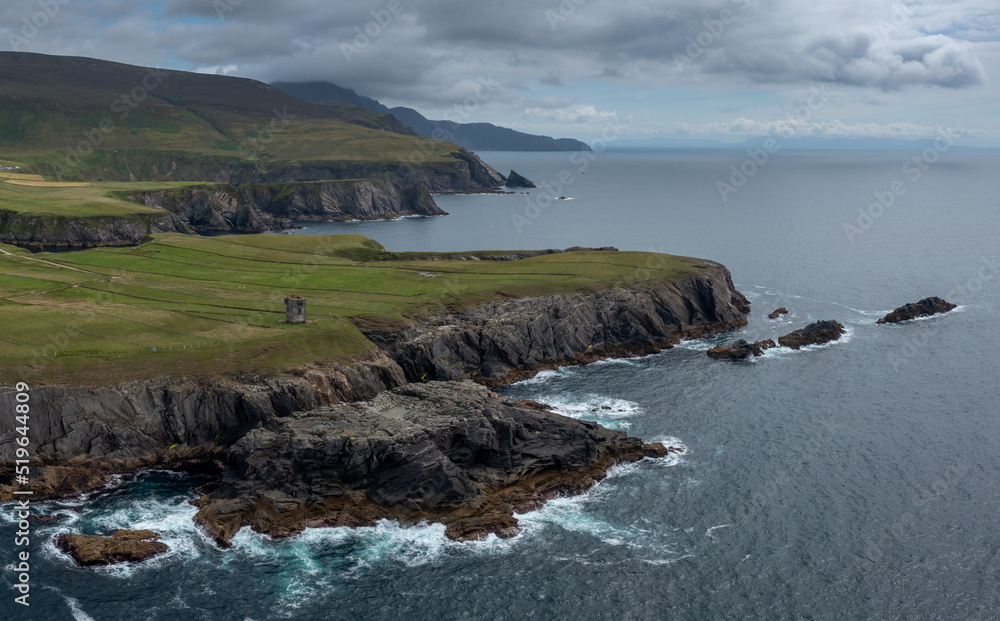 the rugged coastline of County Donegal at Malin Beg with the ruins of the Napoleonic signal tower on the cliff edge