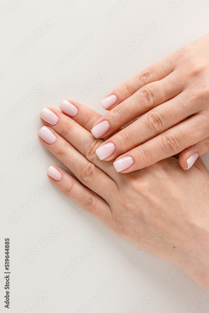 Female hands with beautiful nails with stylish trendy nude manicure. Female hands with beautiful nails with stylish trendy nude manicure.