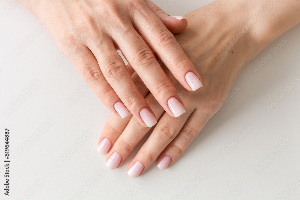 Female hands with beautiful nails with stylish trendy nude manicure. Female hands with beautiful nails with stylish trendy nude manicure.