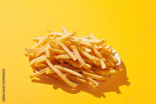 French fries on yellow pastel background