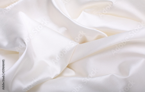 White beige pearl wave fabric silk. Abstract texture horizontal copy space background.