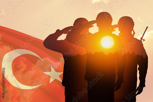 Double exposure of Silhouettes of a soliders and the sunset or the sunrise against Turkey flag. Concept of crisis of war and conflicts. Greeting card for Turkish Armed Forces Day, Victory Day.