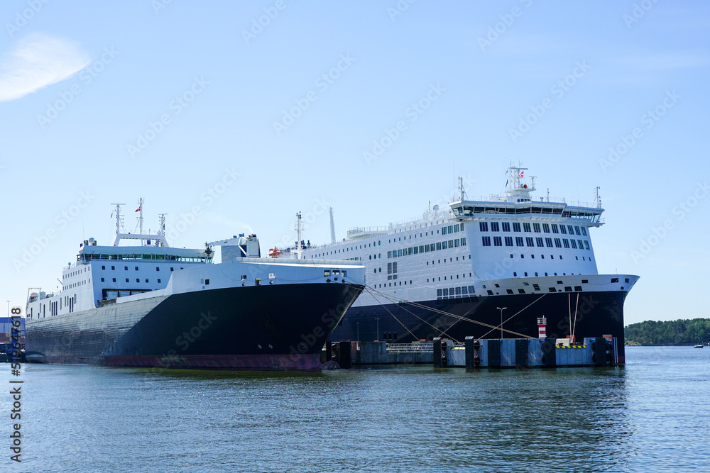 Two large cargo and passenger ferries moored in the harbor