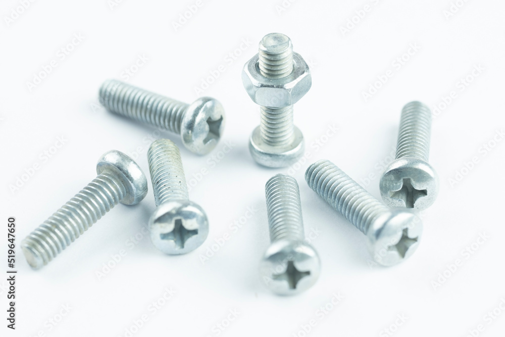 Group of screw-bolts isolated on white. Standing out of the crowd concept. Group of screw-bolts isolated on white. Standing out of the crowd concept.