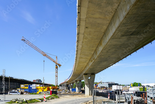 New modern road overpass concrete bridge construction site with yellow tower crane