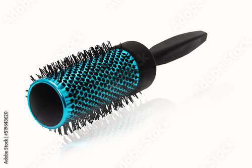 Blue hair comb brush with handle isolated on white.