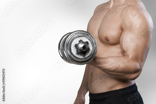 Workout and gym concept. Handsome man showing his muscles after sport exercises, flexing biceps