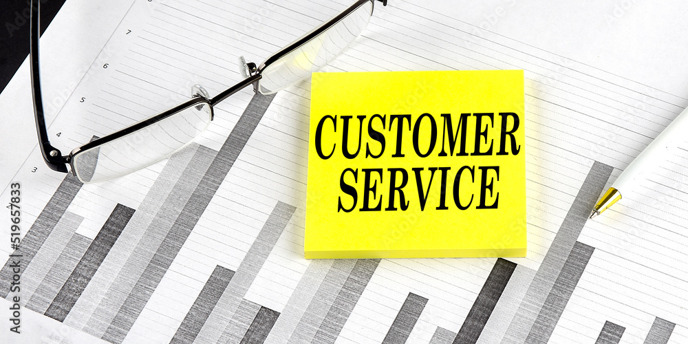 Word CUSTOMER SERVICE on yellow sticky on the chart background Word CUSTOMER SERVICE on yellow sticky on the chart background