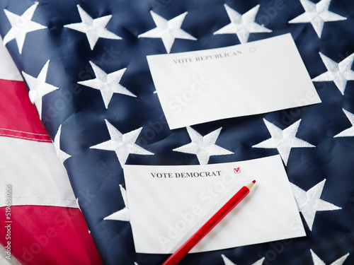 Two sheets of paper and a red pencil. Captions - Vote Democrat, Vote Republican. The background is the state American flag. Poll before the US parliamentary elections. questionnaire.