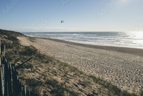 View of the beach of the south of France with a surfer on the water in the dream sunset