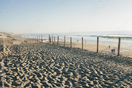 View of the beach of the south of France with a surfer on the water in the dream sunset