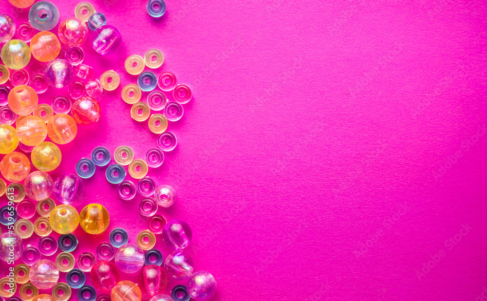 Colorful Plastic Beads on pink Background. Kid's DIY Craft. Children's Necklace Beads Colorful Plastic Beads on pink Background. Kid's DIY Craft. Children's Necklace Beads