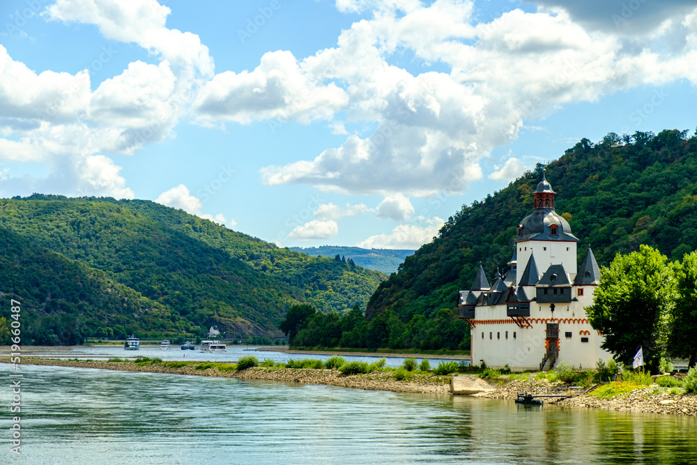 castle on the lake near Frankfurt and Hesse region on a sunny day.  Riverside castle in Germany with blue sky above