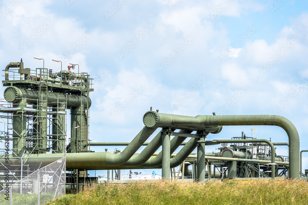 Pipelines and valves at a natural gas extraction site. Groningen gas field, the Netherlands. Pipelines and valves at a natural gas extraction site. Groningen gas field, the Netherlands.